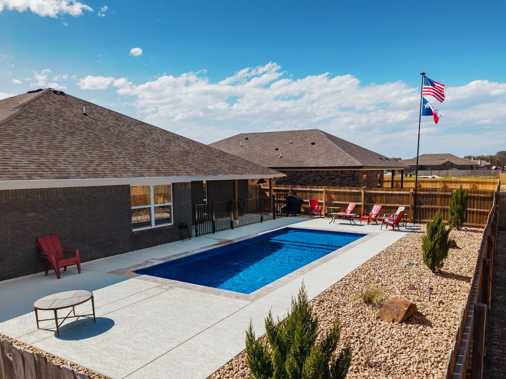 Expert POOL-ology team meticulously installing a reliable fiberglass pool in a Lago Vista home