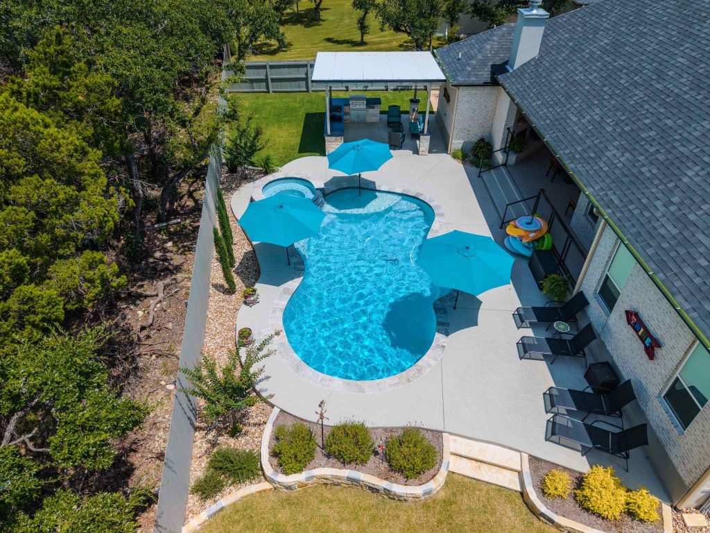 Skilled POOL-ology craftsmen work diligently on premier fiberglass pool construction in Jonestown, TX, ensuring top-quality results