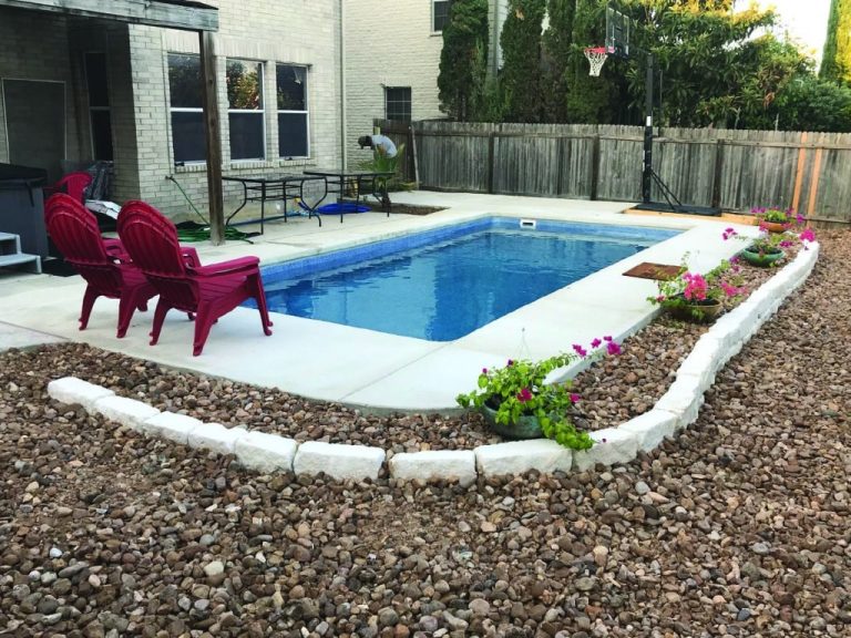 Delray fiberglass pool, kidney-shaped freeform design with dual handrails and stamped concrete deck