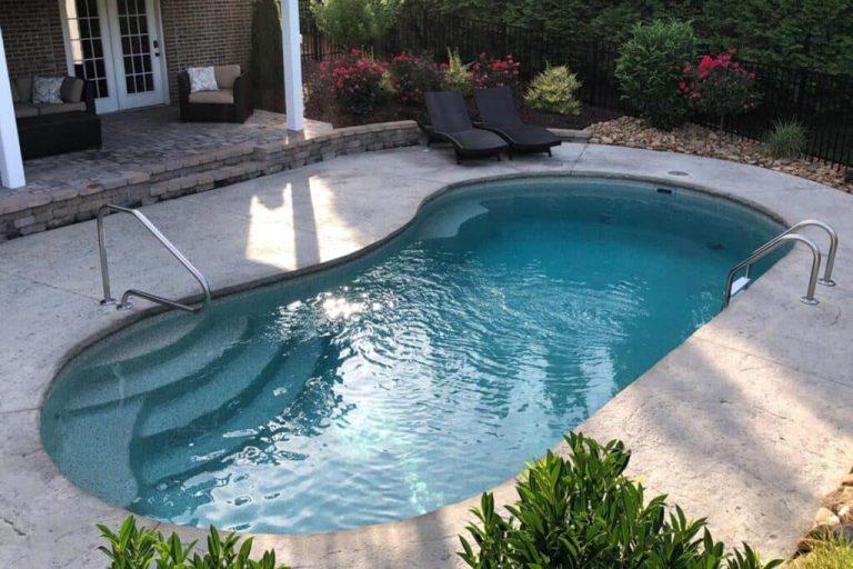 Jamaica 14 fiberglass pool, freeform design with rock waterfall feature and flagstone deck