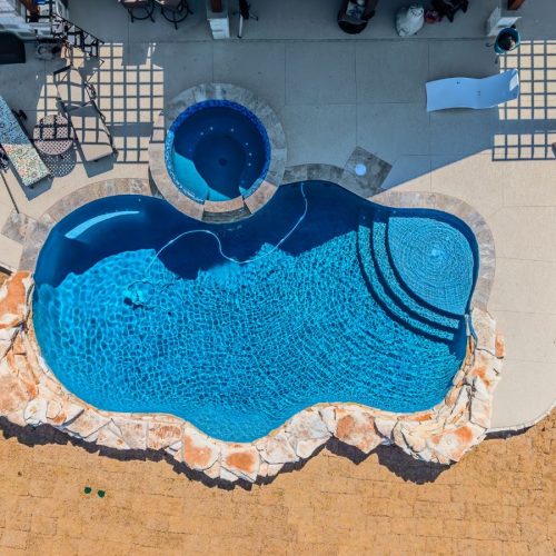 POOL-ology specialist building a fiberglass pool in Springbrook, TX, enhancing a modern outdoor living area.