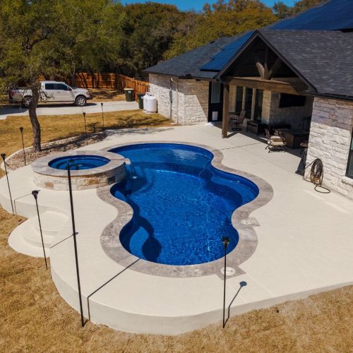 A POOL-ology expert in Springbrook, TX, showcasing premium fiberglass pool design tailored to the local climate and lifestyle. Fiberglass Pool Construction near me.